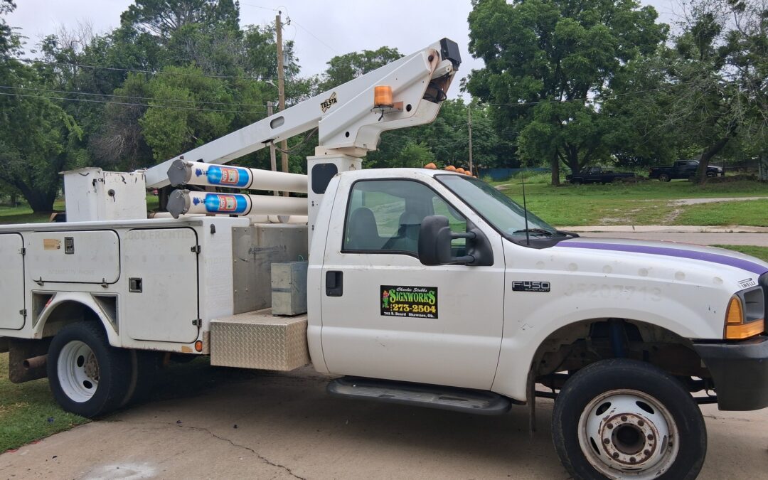 Side view of Signworks bucket truck.
